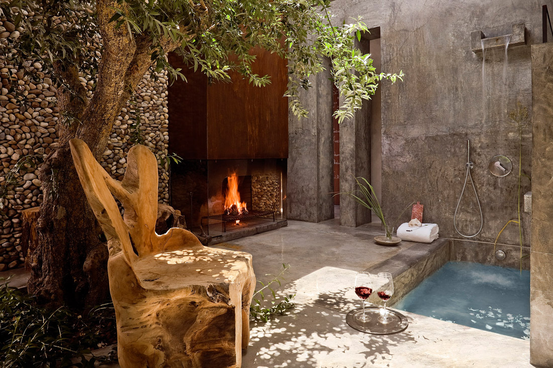Outdoor space with bath and fireplace