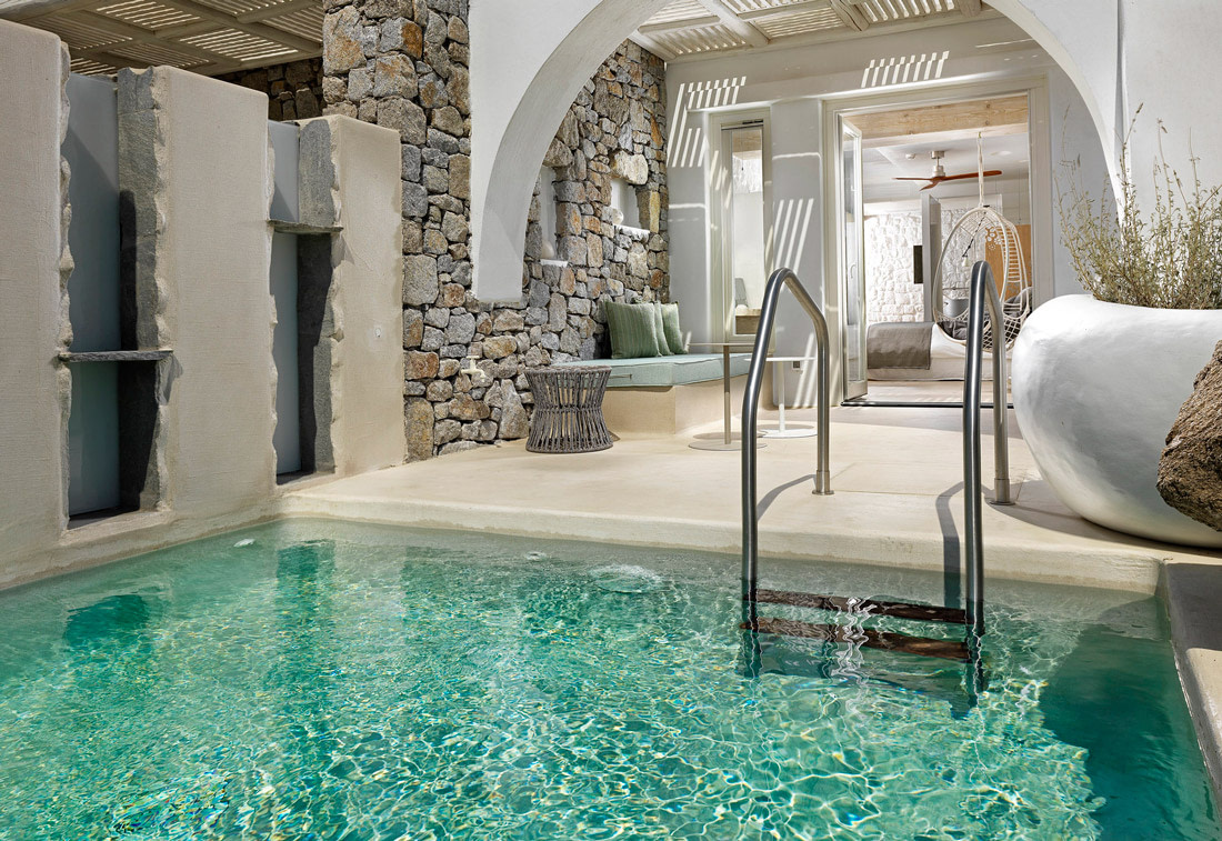 Open-air bedroom with plunge pool